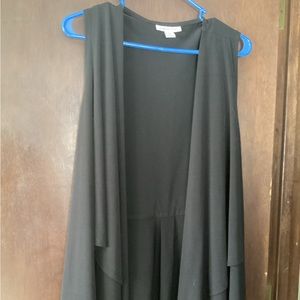 Knit vest with ruffled bottom.